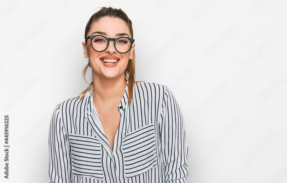 Young caucasian woman wearing business shirt and glasses with a happy and cool smile on face. lucky person. Young caucasian woman wearing business shirt and glasses with a happy and cool smile on face. lucky person.