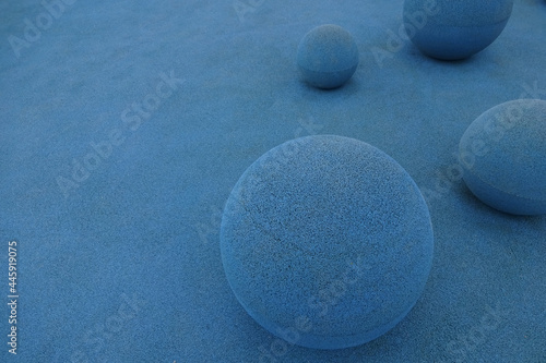 Close up of a light blue color stone balls on grained textured background. Abstract wallpaper or backdrop. Spheric shape.