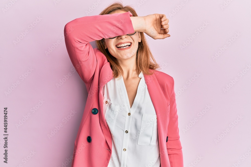 Young caucasian woman wearing business style and glasses covering eyes with arm smiling cheerful and funny. blind concept. Young caucasian woman wearing business style and glasses covering eyes with arm smiling cheerful and funny. blind concept.