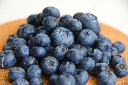 blueberry berries on a wooden and white background