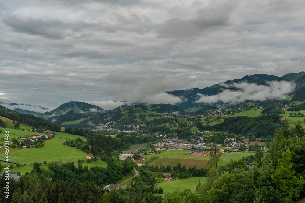 Hills and valley near Sankt Johann im Pongau with fog and green meadows