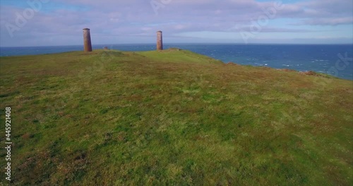 Aerial: Brownstown Head Pillars, coastline, farmland and cows, Tramore, Ireland photo