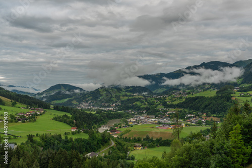 Hills and valley near Sankt Johann im Pongau with fog and green meadows photo