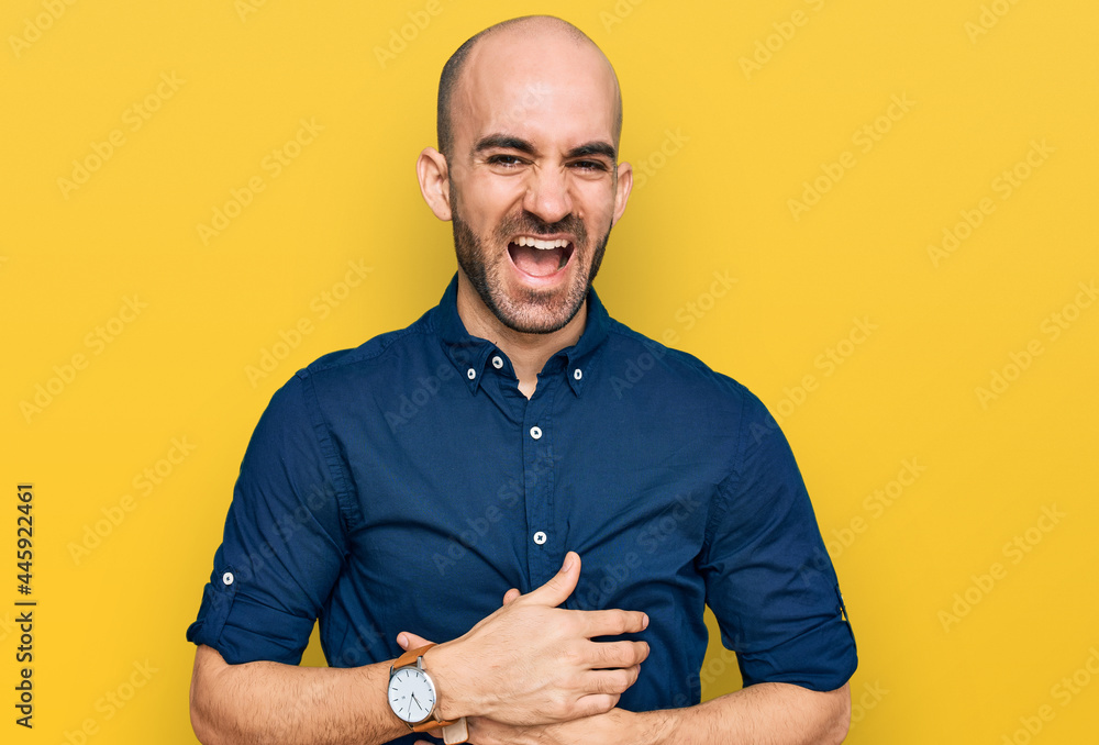 Young hispanic man wearing casual clothes smiling and laughing hard out loud because funny crazy joke with hands on body. Young hispanic man wearing casual clothes smiling and laughing hard out loud because funny crazy joke with hands on body.