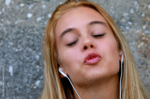 Cute sexy young woman posing for a kiss with pursed lips