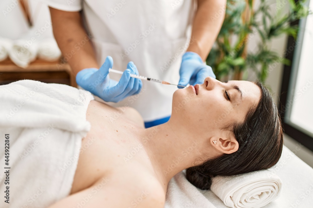 Doctor man injecting botox on woman lips for anti aging treatment at the clinic. Doctor man injecting botox on woman lips for anti aging treatment at the clinic.