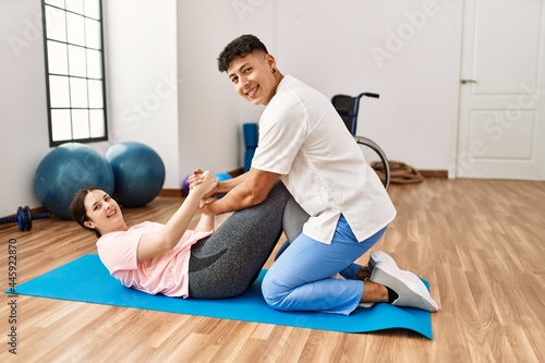 Physioterapist man giving treatment to woman at the clinic.