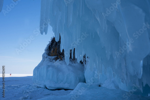 rocks with ice overlaps and icicles near the lake