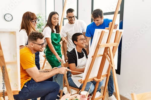 Group of people smiling happy and looking draw of partner at art studio.