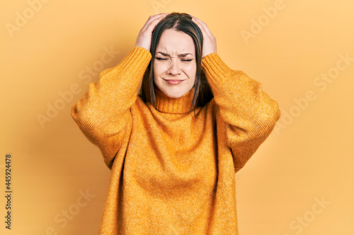 Young hispanic girl wearing casual clothes suffering from headache desperate and stressed because pain and migraine. hands on head. © Krakenimages.com