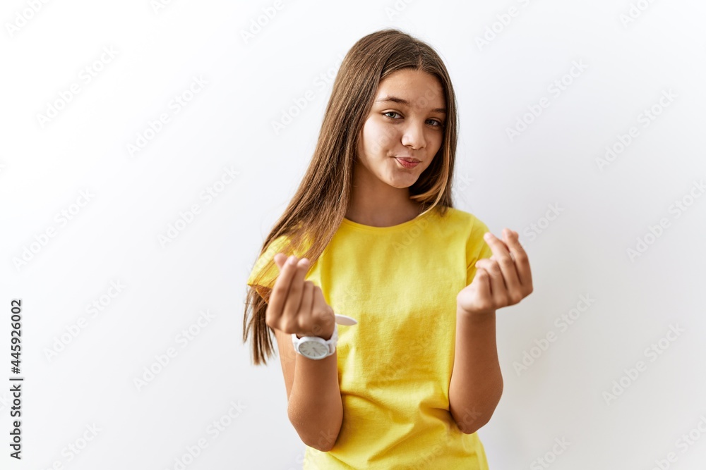 Fototapeta premium Young brunette teenager standing together over isolated background doing money gesture with hands, asking for salary payment, millionaire business