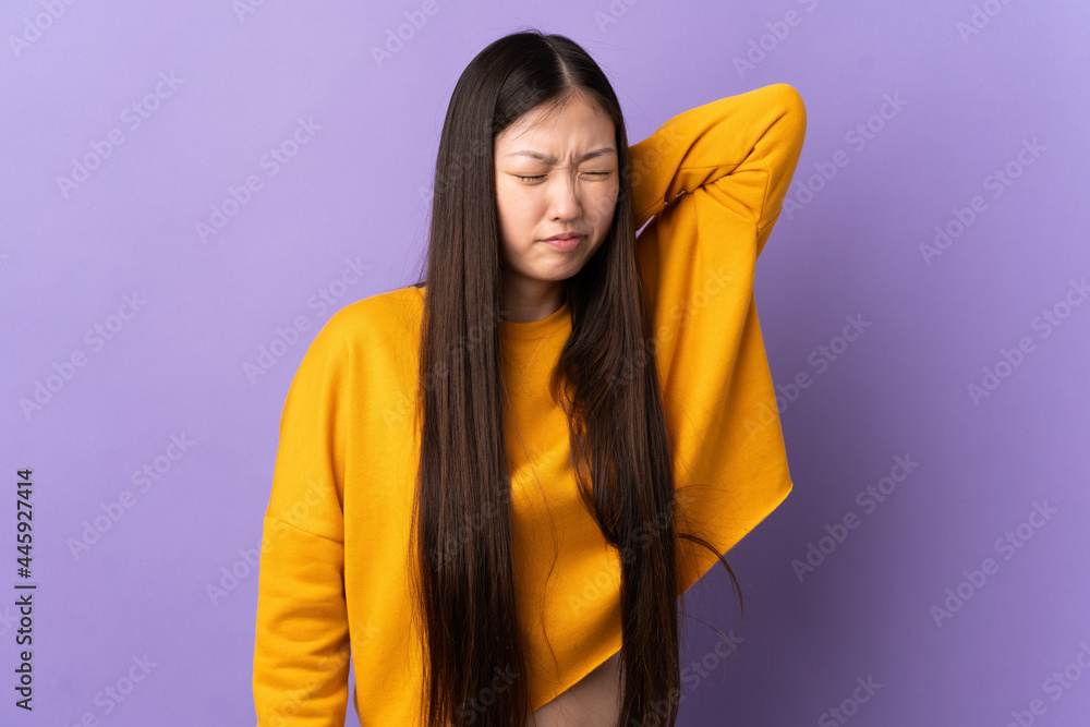 Young Chinese girl over isolated purple background with neckache Young Chinese girl over isolated purple background with neckache