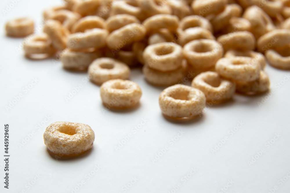 Closeup of a heap of Cereal cheerios on white background, rings breakfast cereal