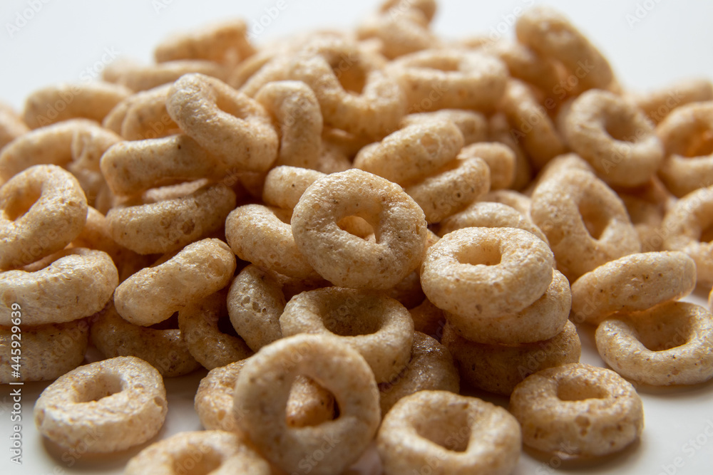 Closeup of a heap of Cereal cheerios on white background, rings breakfast cereal
