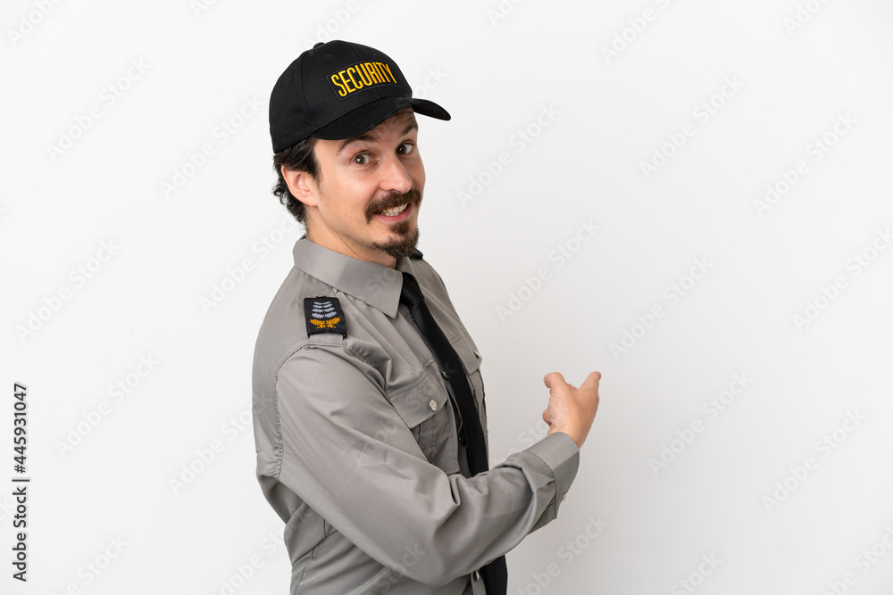 Young caucasian security man isolated on white background pointing back Young caucasian security man isolated on white background pointing back