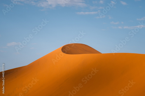 Towering sand dunes in the Namib desert at sunrise near Sossusvlei, Namib-Naukluft National Park, Namibia, Africa.
