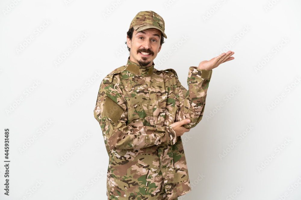 Soldier man isolated on white background extending hands to the side for inviting to come Soldier man isolated on white background extending hands to the side for inviting to come