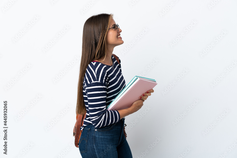 Young student woman isolated on white background laughing in lateral position Young student woman isolated on white background laughing in lateral position