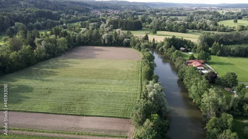 A river in bright sunshine with a field