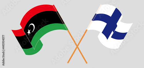 Crossed and waving flags of Libya and Finland
