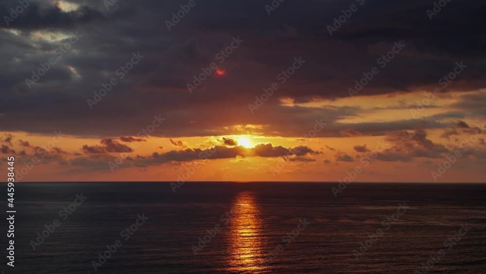 Colorful sunset over the calm sea through the clouds in the evening sky 4k uhd timelapse video Colorful sunset over the calm sea through the clouds in the evening sky 4k uhd timelapse video