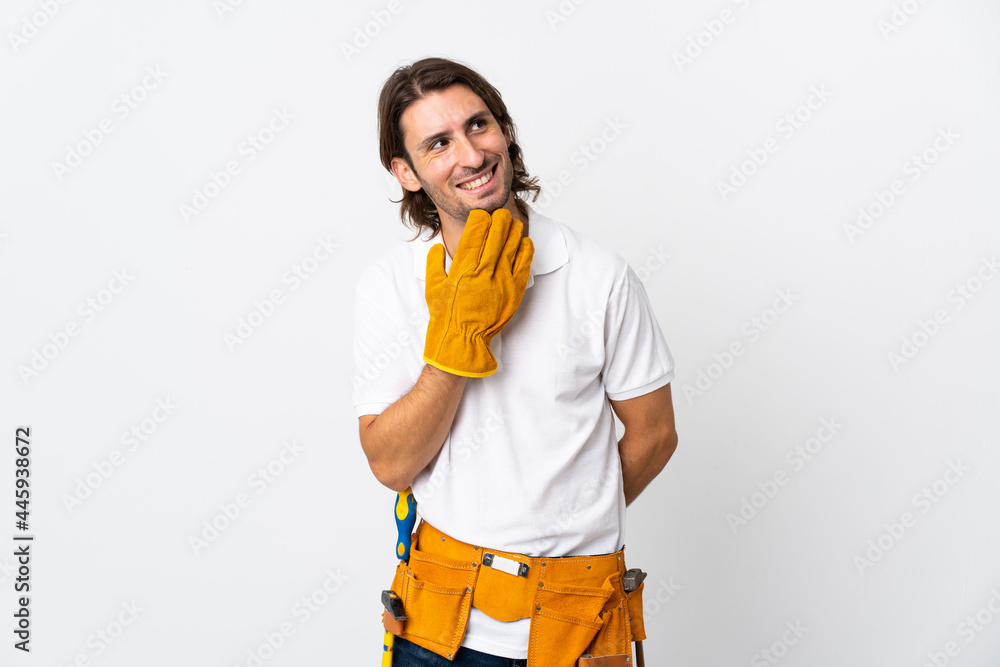 Young electrician man over isolated background looking up while smiling Young electrician man over isolated background looking up while smiling