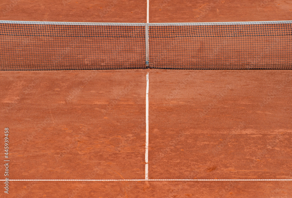 Fototapeta premium Empty clay tennis court and net. Professional sport concept. Horizontal sport poster, greeting cards, headers, website