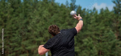 Sportsman practising shot put. Professional sport concept. Horizontal sport poster, greeting cards, headers, website photo