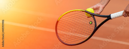 Tennis player prepares to serve a tennis ball during a match. Professional sport concept. Horizontal sport poster, greeting cards, headers, website