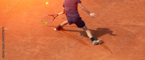 Male tennis player in action on the court on a sunny day. Professional sport concept. Horizontal sport poster, greeting cards, headers, website © Augustas Cetkauskas