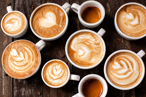 Latte coffee art, rosette decoration, heart shaped latte, wooden background