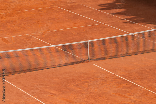 Empty clay tennis court and net. Professional sport concept. Horizontal sport poster, greeting cards, headers, website © Augustas Cetkauskas