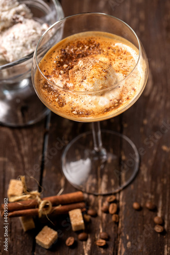 Coffee based beverage in a fancy cocktail glass, coffee beans, brown sugar cubes © didesign