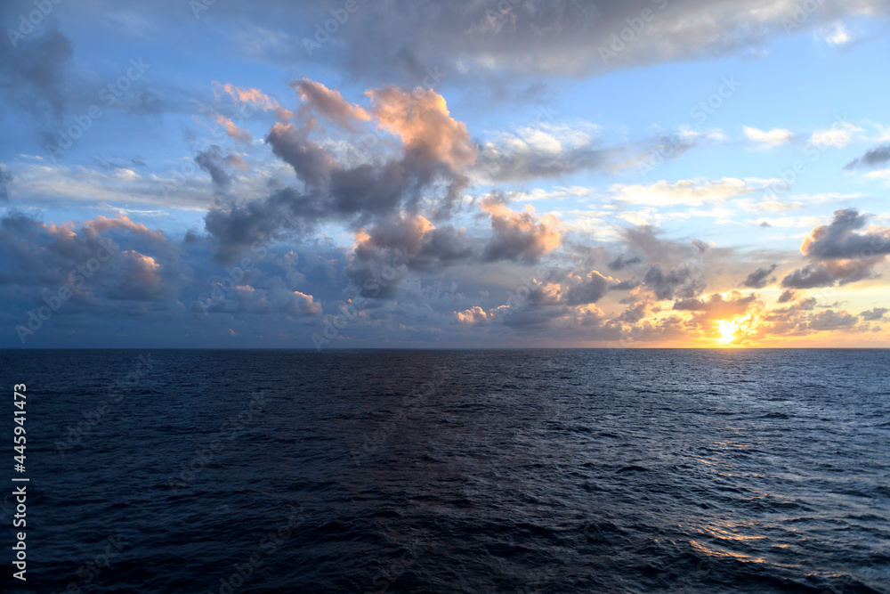 Seascape, blue sea. Sunset at sea. Calm weather. View from cargo vessel. Work at sea. Commercial shipping.