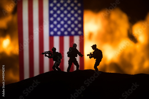 Flag on burning dark background. Concept of crisis of war and political conflicts between nations. Selective focus photo