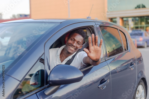 An African-American man driving a car. Human emotions