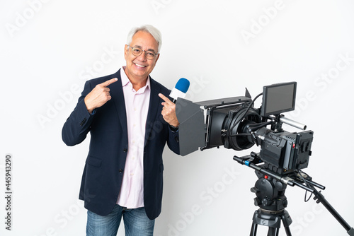 Reporter Middle age Brazilian man holding a microphone and reporting news isolated on white background giving a thumbs up gesture