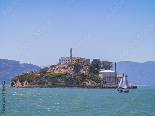 Sunny view of the Alcatraz Island and San Francisco Bay with a boat