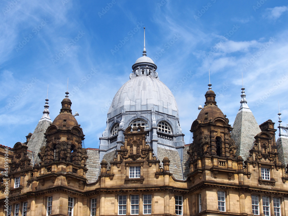 ornate stone towers and domes on the roof of leeds city market a historical building in west yorkshire england