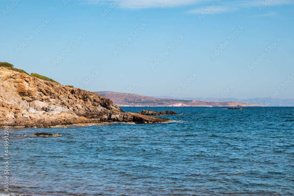 Rocky cliff with blue sea shore landscape near Athens, Greece. Vibrant colorful summer view with blue clear Mediterranean sea
