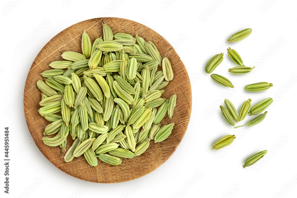 Dried fennel seeds in wooden bowl isolated on white background with clipping path. Top view. Flat lay Dried fennel seeds in wooden bowl isolated on white background with clipping path. Top view. Flat lay