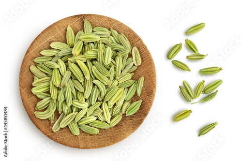 Dried fennel seeds in wooden bowl isolated on white background with clipping path. Top view. Flat lay