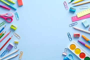 Flat lay colorful school supplies on blue background. Back to school concept. Top view, overhead.