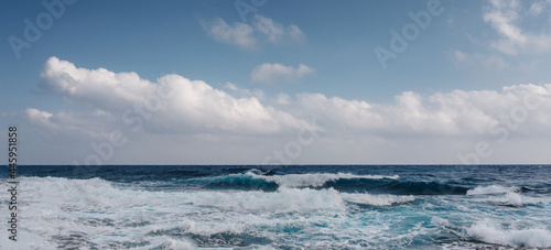 Sea waves crash on the rough rocky shore © undrey