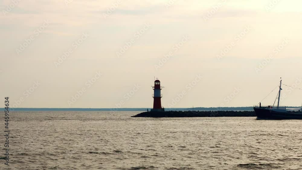 Lighthouse of Warnemuende and coastline of baltic sea in Rostock Lighthouse of Warnemuende and coastline of baltic sea in Rostock