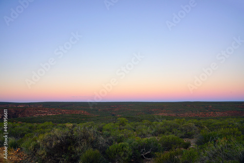 Sunset view of a pink sky over trees in Kalbarri National Park in the Mid West region of Western Australia