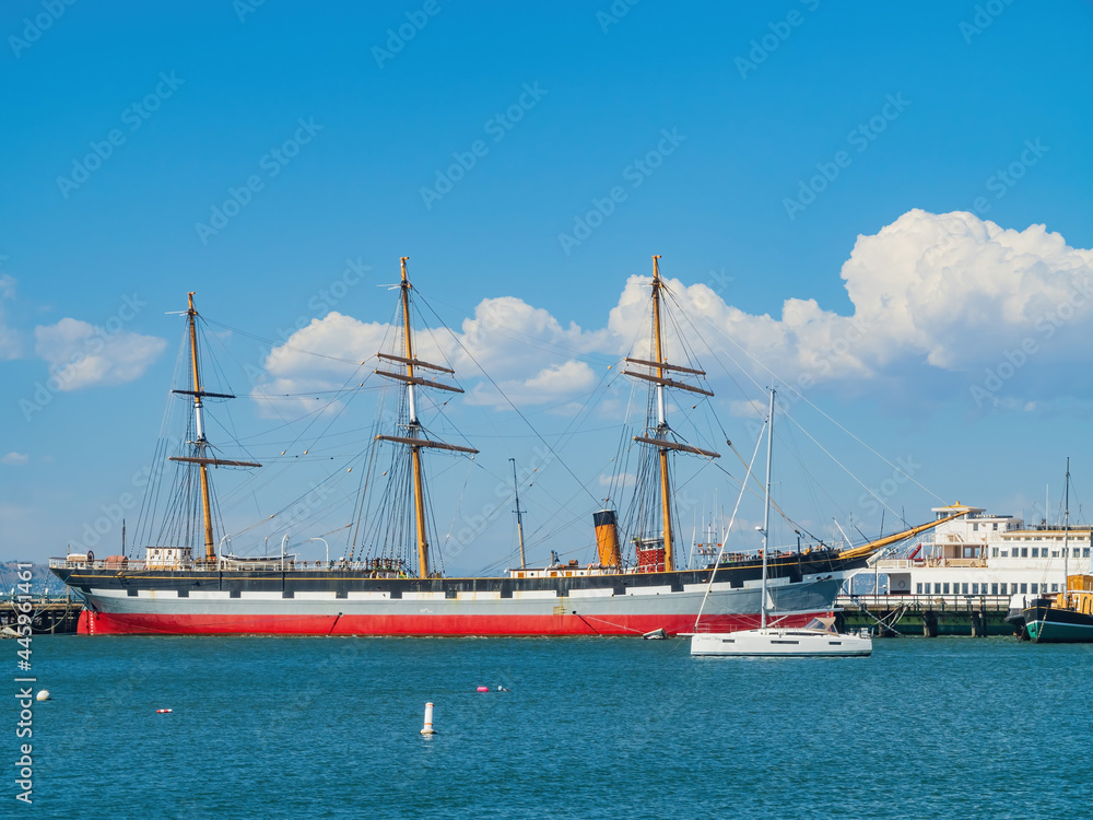 Red vessel ship parked at the pier