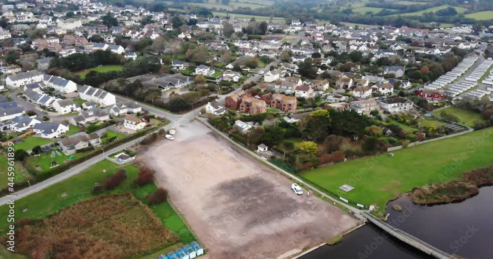 Aerial Over River Char With View Of Empty Car Park In Charmouth Village In Dorset. Dolly Forward Aerial Over River Char With View Of Empty Car Park In Charmouth Village In Dorset. Dolly Forward