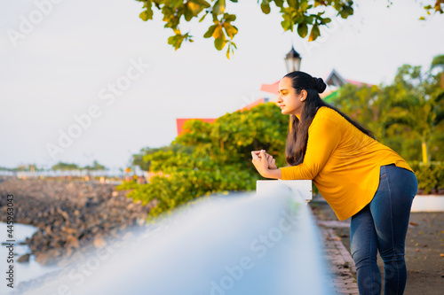 woman thinking leaning with her hand to the wall in the park
