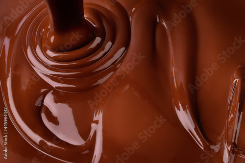 melted dark chocolate background. pouring liquid cocoa dessert